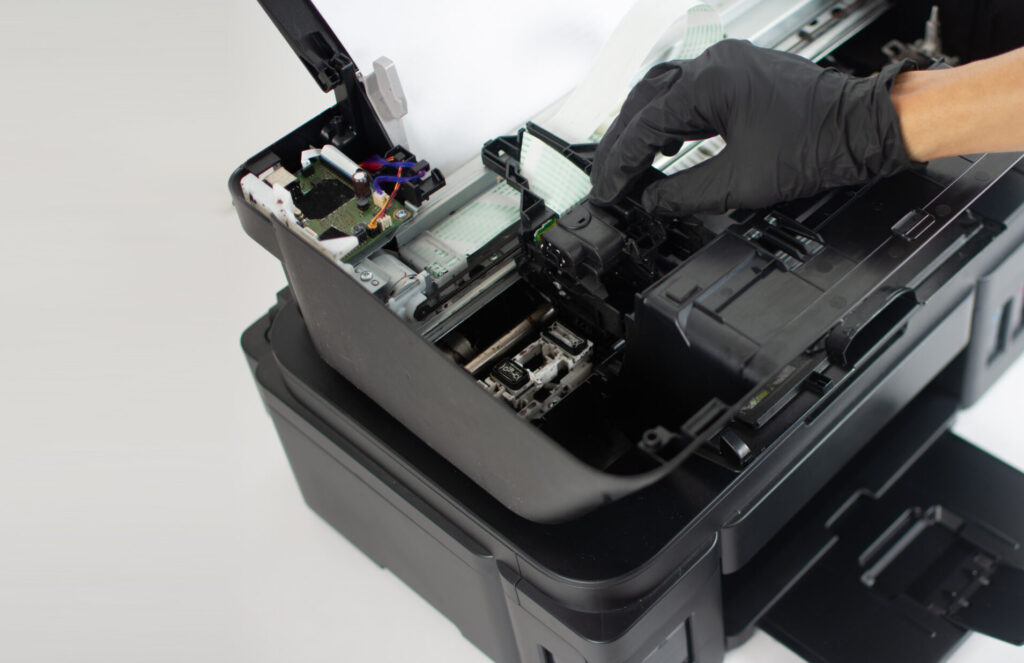 Printer repairman inspecting printer interior.Copy space. Concept of professional printer maintenance Technical assistance in office hardware Continuous repair of the ink system. Printer problems ..